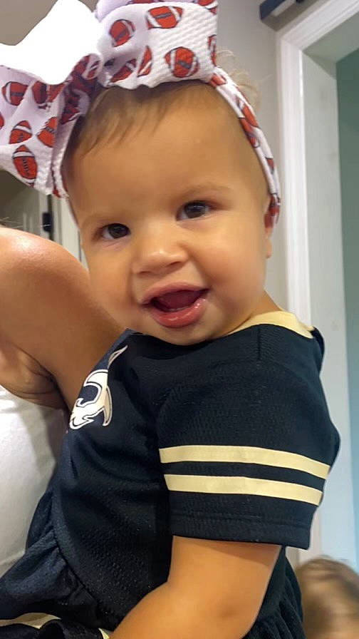 Eliana Rose is registered to the contest to win money with this photo: arm, baby, baby_toddler_clothing, cheek, chin, cool, eye, eyebrow, finger, happy, headgear, human_body, lip, mouth, neck, person, skin, sleeve, smile, toddler