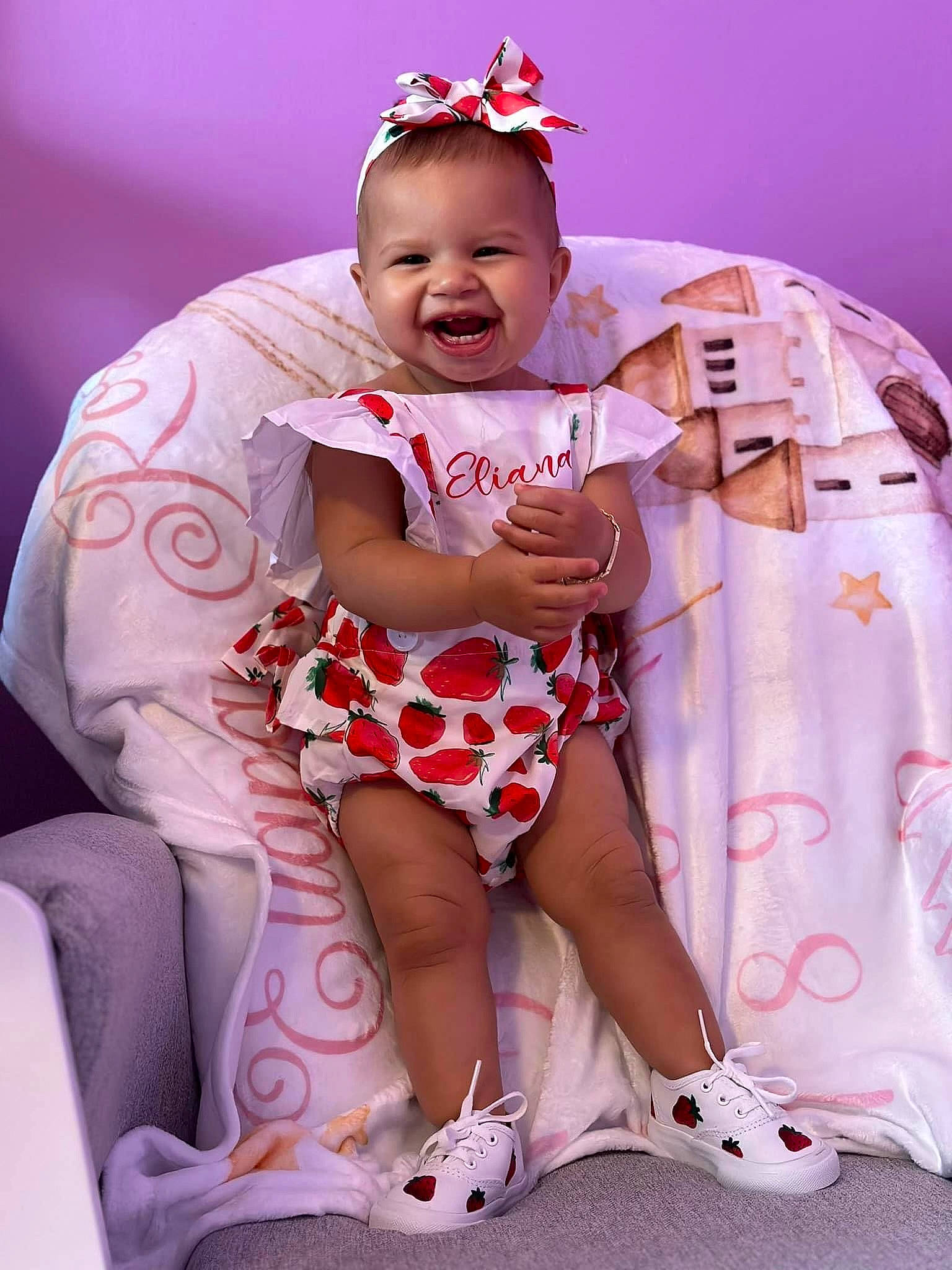 Eliana Rose is registered to the contest to win money with this photo: baby, baby_toddler_clothing, chair, child, eye, fun, happy, headpiece, human_body, human_leg, magenta, pattern, person, pink, purple, sitting, skin, smile, thigh, toddler