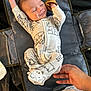 baby, infant, sleeping, onesie, mittens, animal_print, hand, changing_mat, cute, smile, sleepy, newborn, clothing, fabric, bedroom, resting, comfort, soft, indoor, person