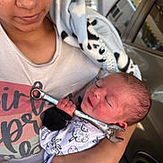 Kenan is registered to the contest to win money with this photo: baby, blanket, car, closeup, clothing, cute, face, freckles, hand, holding, infant, newborn, nose_piercing, outdoor, panda_pattern, person, sleeping, smile, tenderness, wrench