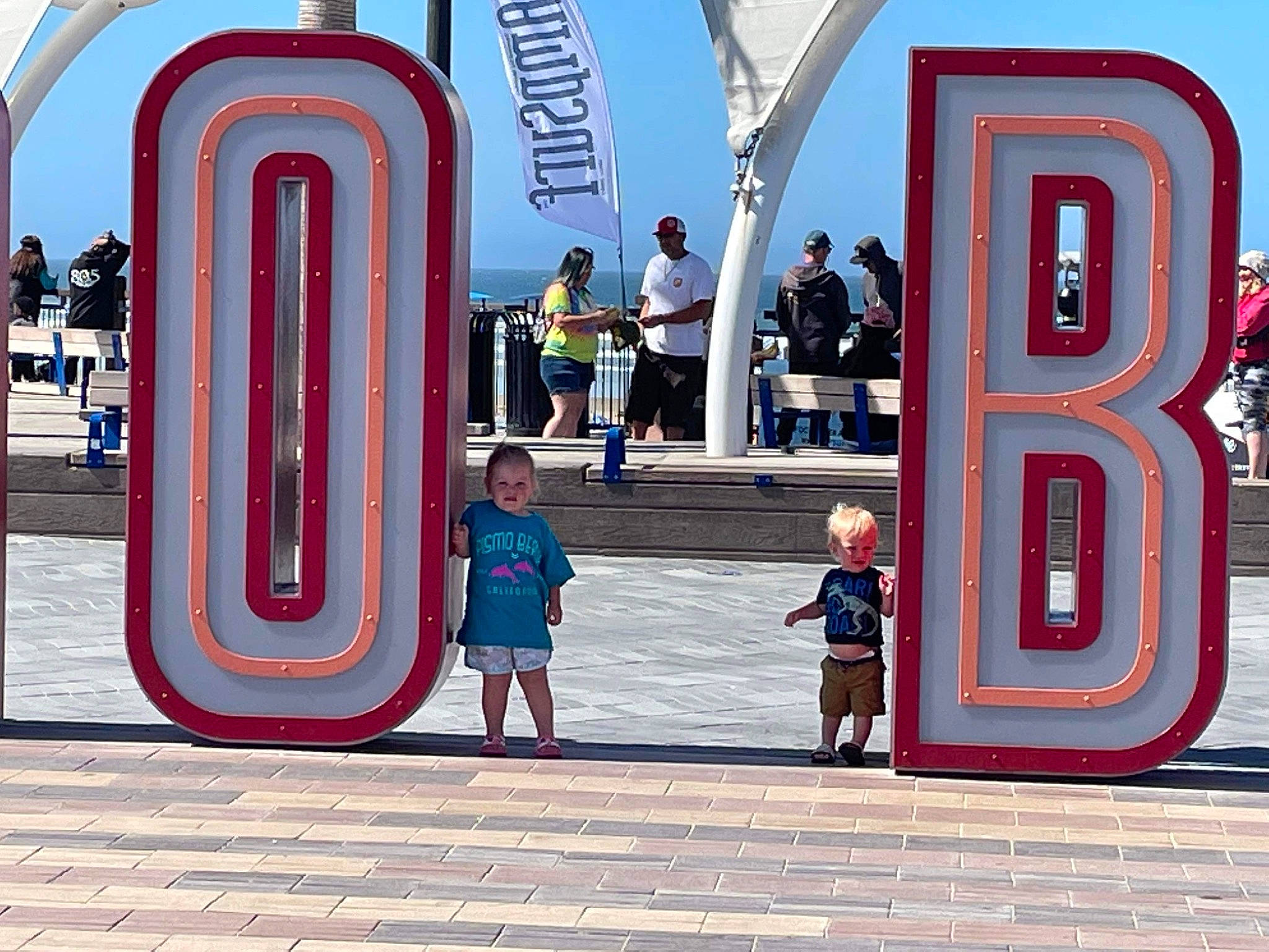 Robert joined the competition — help win amazing prizes! azure, city, electric_blue, facade, font, fun, human, human_settlement, leisure, line, magenta, pedestrian, person, recreation, sky, standing, street, t_shirt, telephone_booth, tourism