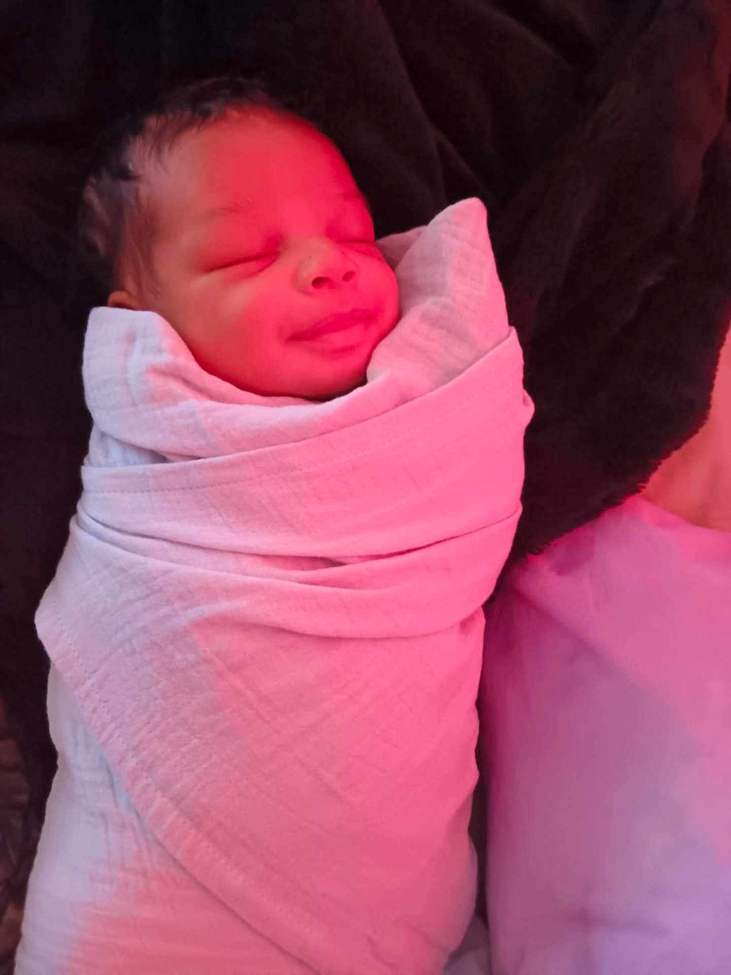 Carmelo is registered to the contest to win money with this photo: baby, newborn, infant, swaddle, blanket, sleeping, smile, portrait, face, head, cozy, bedding, pillow, indoor, blanket_wrap, skin, peaceful, closeup, fabric, soft