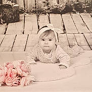 Louciana participe au concours pour gagner de l'argent avec cette photo : baby, infant, headband, bow, flowers, pink, wooden_floor, soft_surface, portrait, cute, child, lying_down, indoors, decor, plush, face, young, cozy, background, props