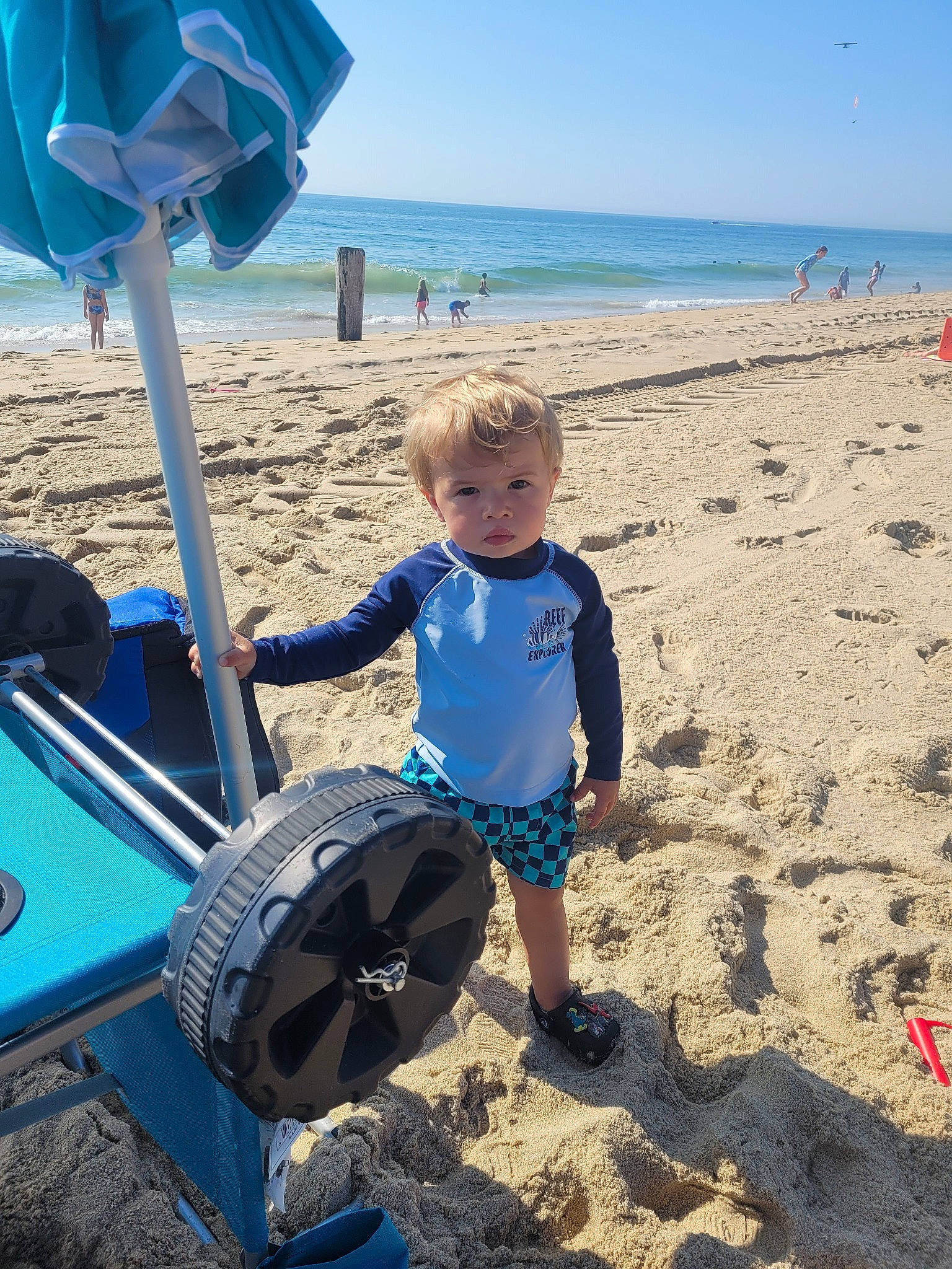 Krew joined the competition — help win amazing prizes! azure, beach, beauty, blue, body_of_water, electric_blue, fun, leisure, natural_environment, outdoor_furniture, people_in_nature, people_on_beach, person, recreation, sand, shorts, sky, summer, toddler, travel