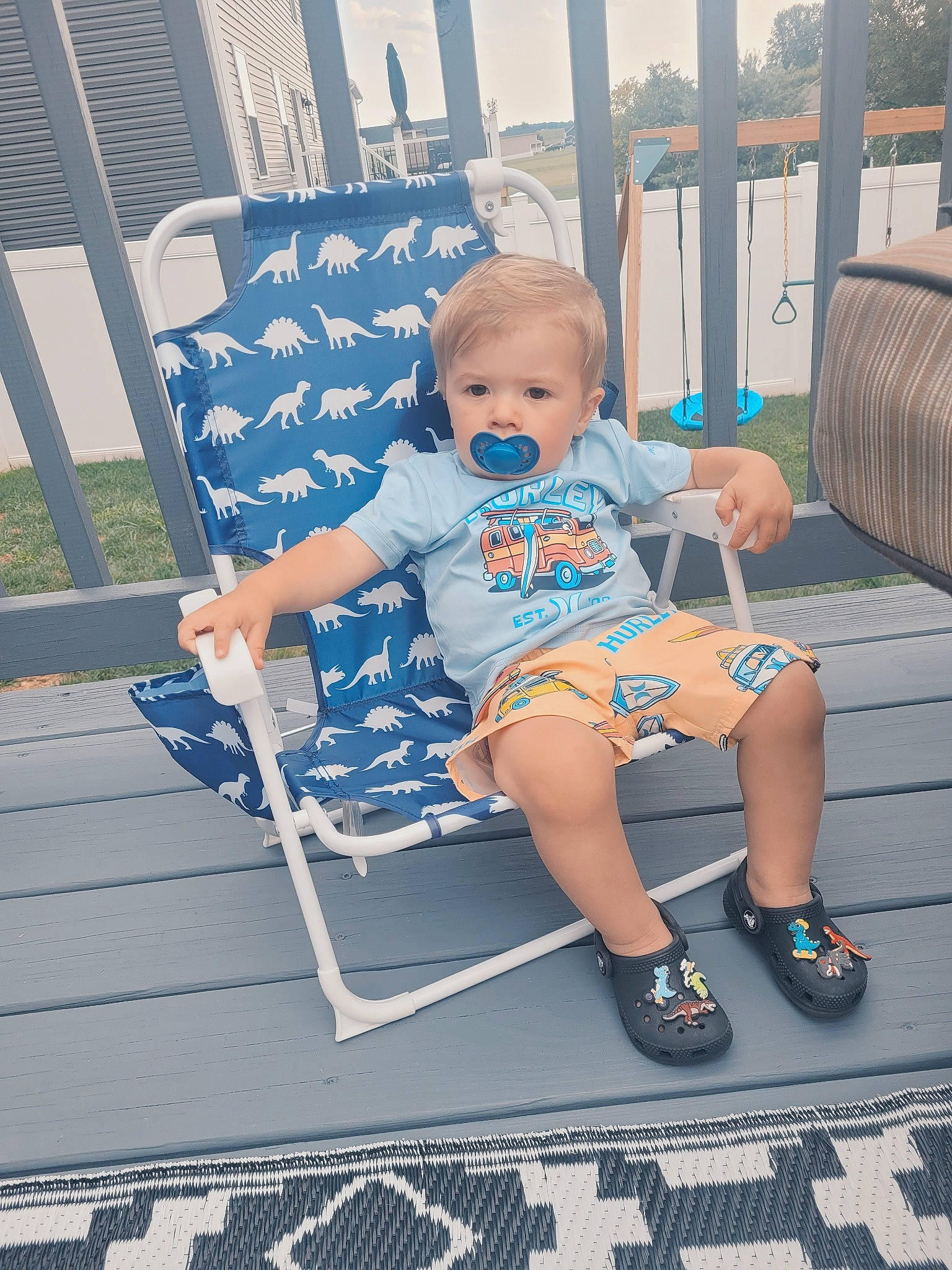 Krew is registered to the contest to win money with this photo: baby, baby_toddler_clothing, child, electric_blue, fence, folding_chair, foot, fun, grass, happy, human_leg, leisure, line, outdoor_furniture, person, recreation, shorts, sitting, thigh, toddler