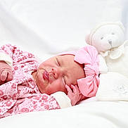 Anaya participe au concours pour gagner de l'argent avec cette photo : baby, newborn, infant, sleeping, pout, pink_headband, teddy_bear, stuffed_animal, blanket, bedding, onesie, patterned_clothing, cute, soft_toy, portrait, close_up, peaceful, nursery, hand, white_background