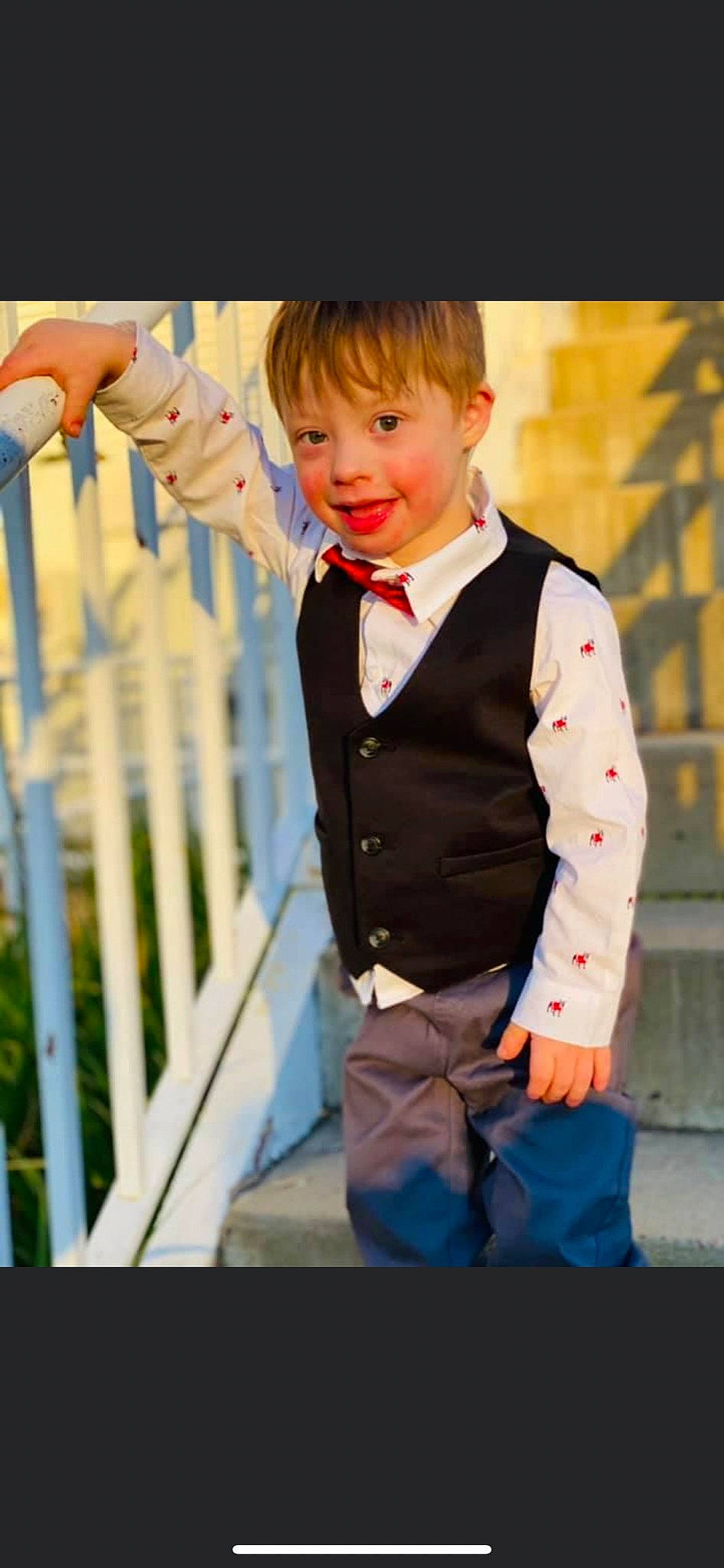 Allen is registered to the contest to win money with this photo: blazer, bow_tie, button, child, collar, dress_shirt, electric_blue, fence, formal_wear, fun, happy, joy, people, people_in_nature, person, sleeve, smile, street_fashion, suit, tie
