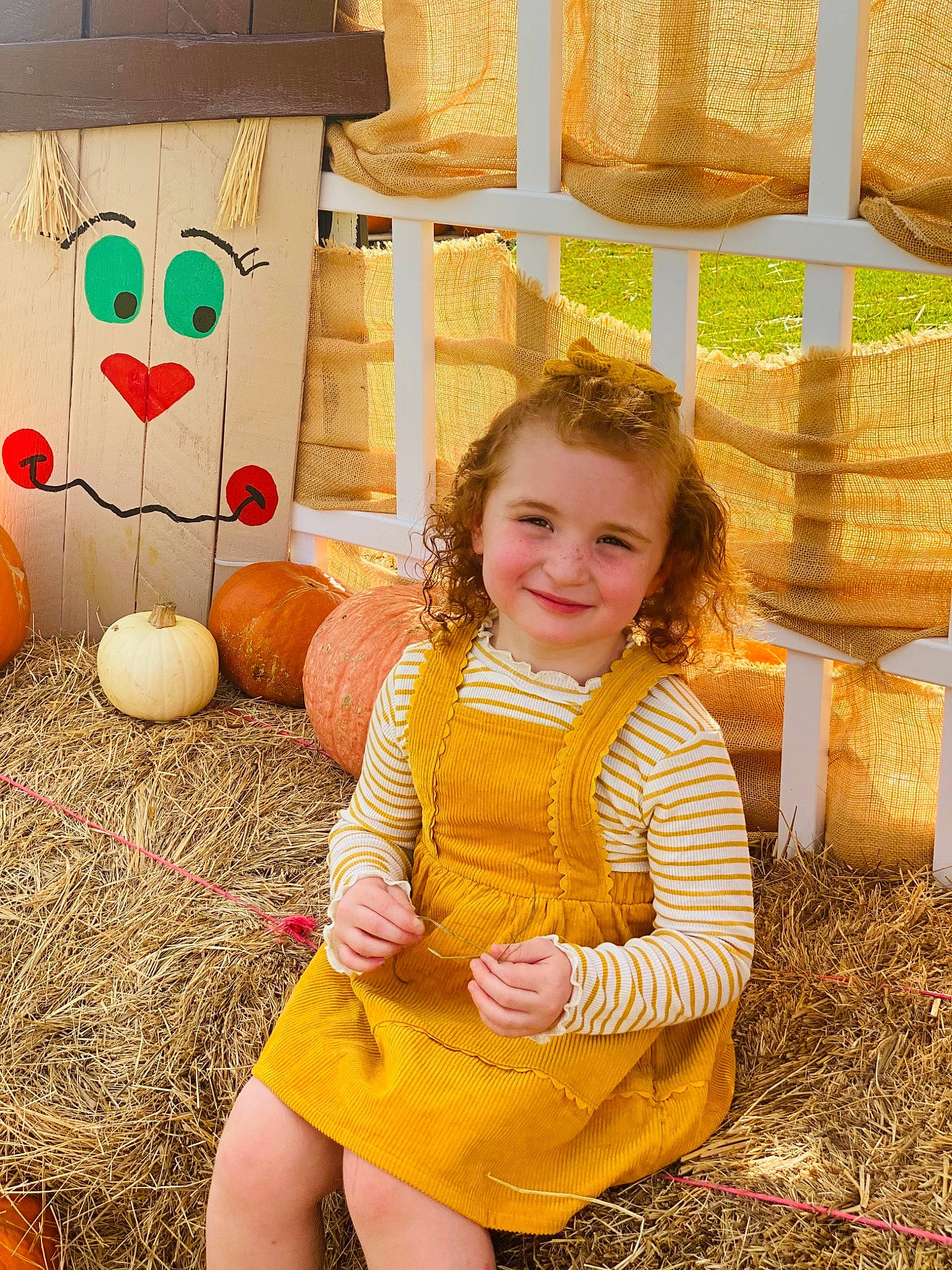 Madilynn is registered to the contest to win money with this photo: child, community, cucurbita, dress, fun, gourd, grass, hair, happy, joy, leisure, orange, people, people_in_nature, person, photograph, plant, pumpkin, smile, summer