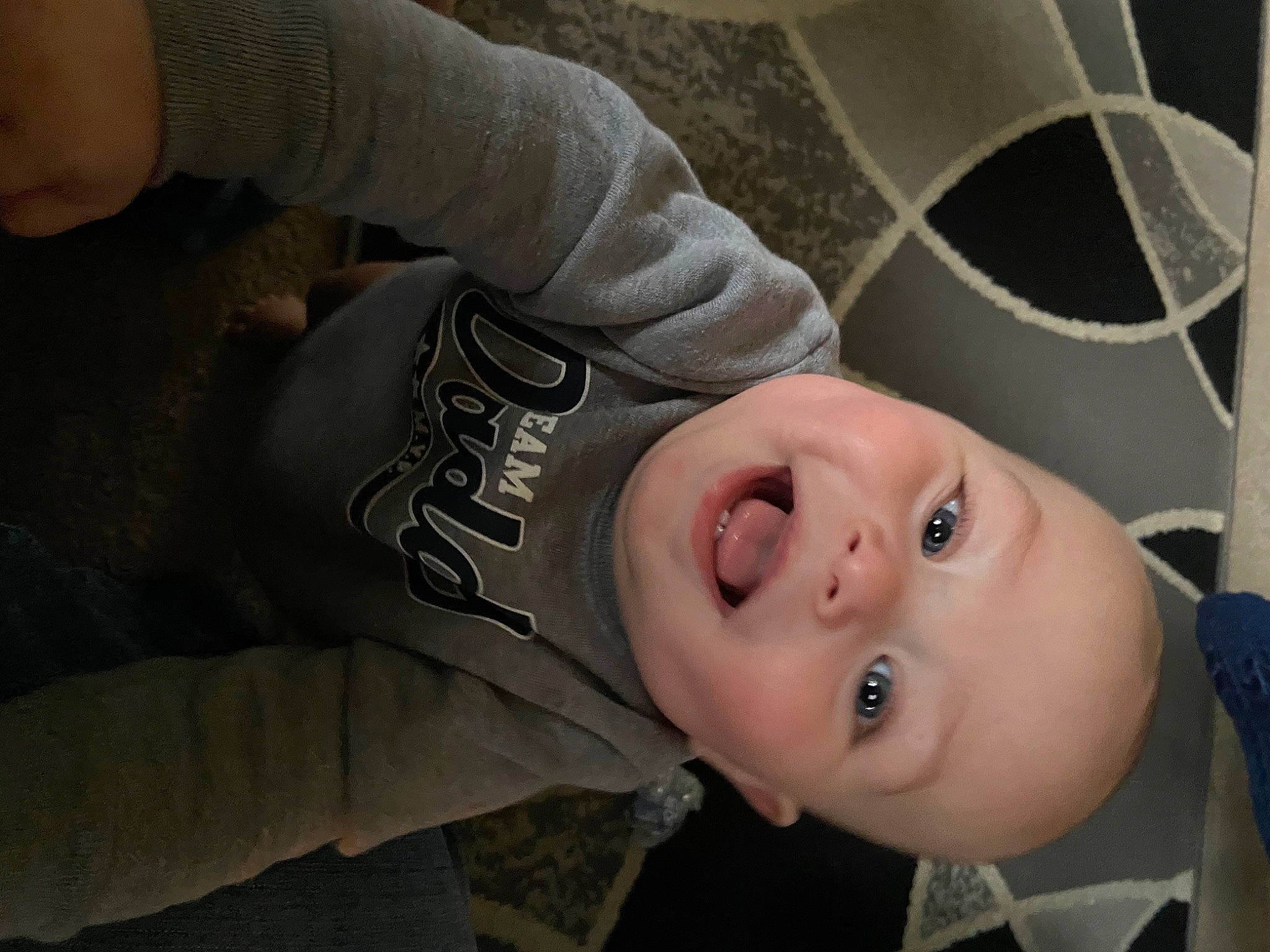 Demetrius joined the competition — help win amazing prizes! baby, cheek, child, comfort, eyelash, flash_photography, grass, happy, hat, lip, mouth, nose, person, portrait_photography, sitting, sleeve, smile, toddler, tree, wood