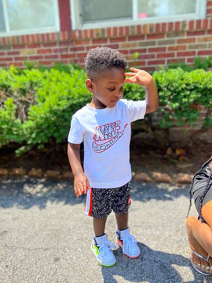 Darius is registered to the contest to win money with this photo: child, child_model, footwear, leisure, pattern, person, plant, play, recreation, shoe, shorts, sleeve, summer, t_shirt, toddler, vacation, walking, yellow