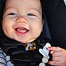 Jax joined the competition — help win amazing prizes! baby, smiling, face, dimple, hand, clothing, car_seat, pacifier, pacifier_clip, beaded_necklace, infant, closeup, happy, child, cute, striped_shirt, black_straps, star_pattern, portrait, indoors