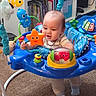 baby, child, activity_jumper, toy, orange_star, red_crab, blue, carpet, bookshelf, books, indoor, floor, clothing, socks, play, smile, person, infant, happy, colorful