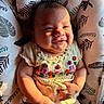 baby, smiling, sunlight, embroidery, ladybug, flowers, cushion, pattern, fabric, cute, infant, hand, face, portrait, child, happy, soft, cozy, texture, colorful