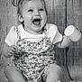 baby, child, smiling, laughing, pigtails, toy, sitting, portrait, black_and_white, clothing, cute, happy, infant, face, foot, hand, texture, fabric, background, playful