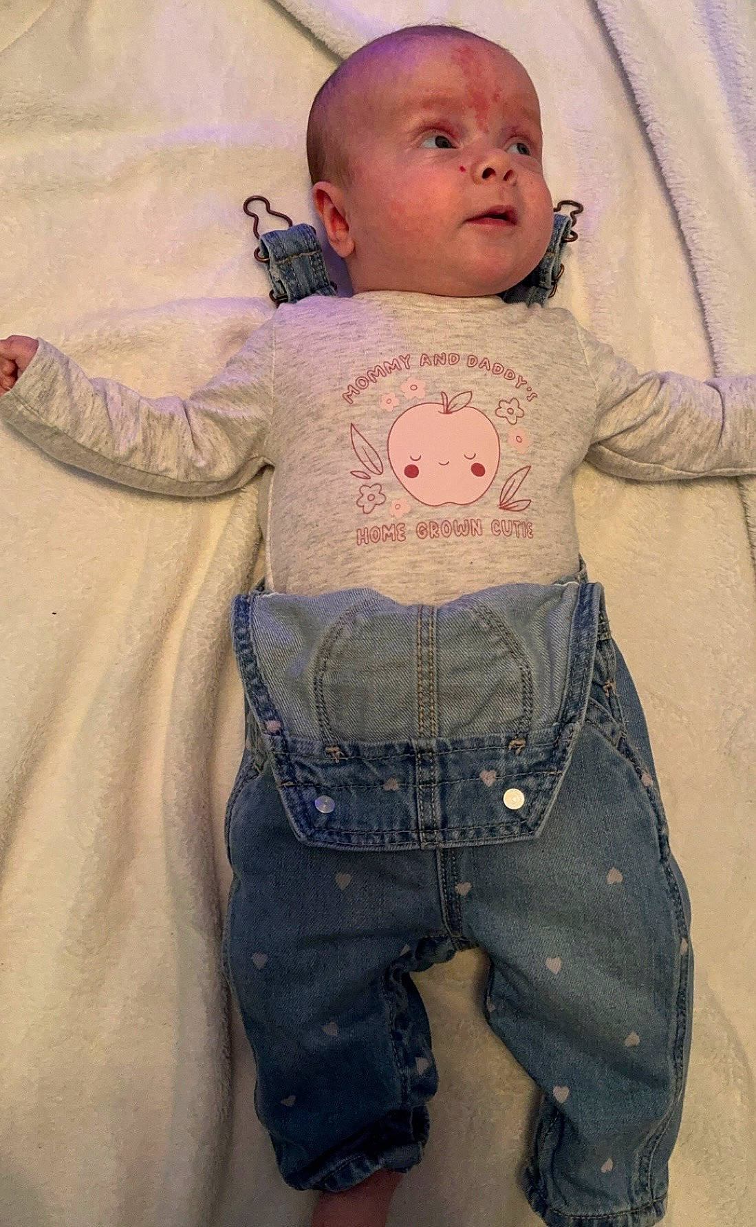 accessories, baby, bed, bodypart, clothing, coat, couch, face, finger, furniture, hand, head, jacket, jeans, newborn, pants, person, photography, portrait, shorts