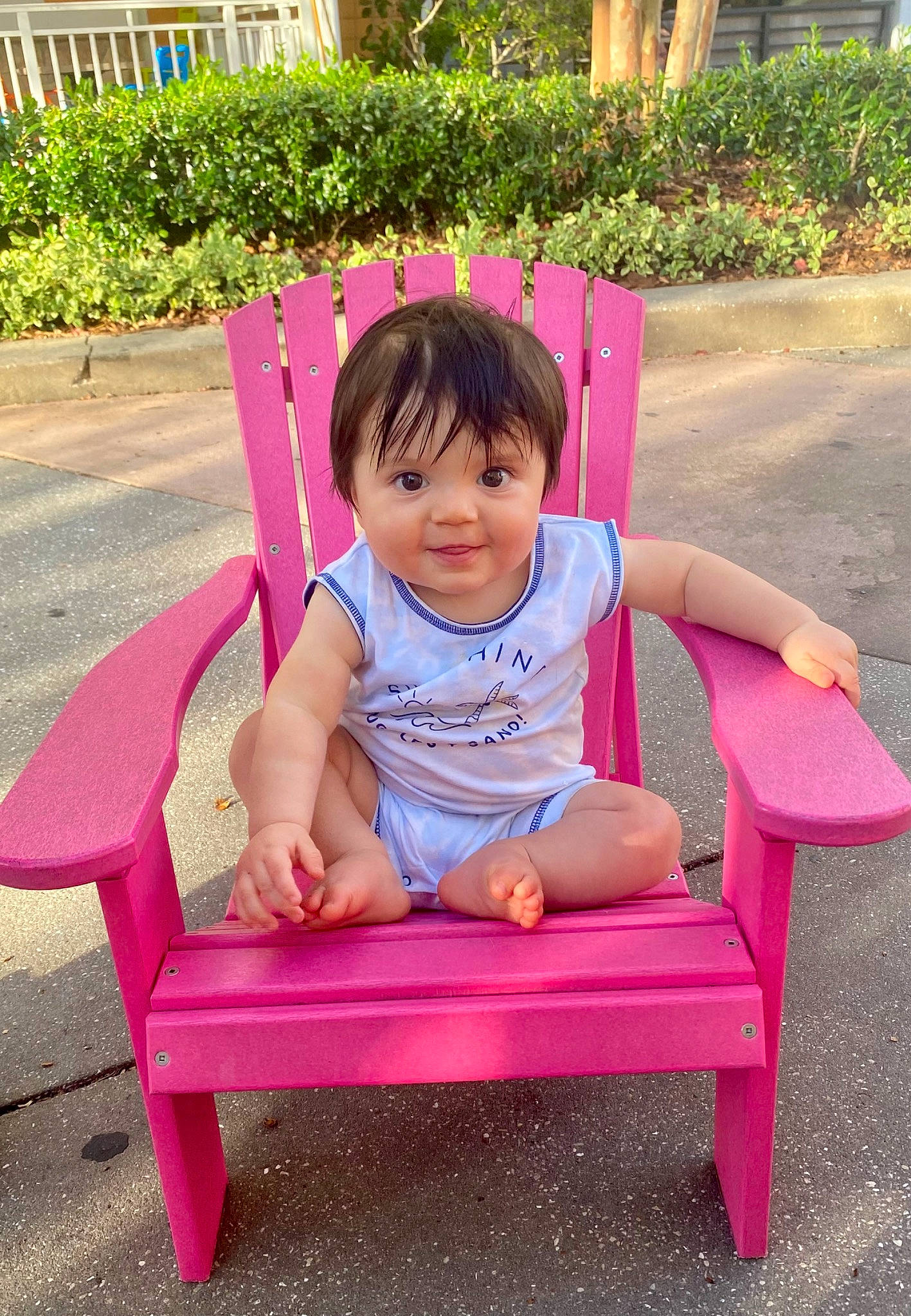 Griffin joined the competition — help win amazing prizes! baby_toddler_clothing, chair, child, comfort, dress, face, fun, grass, happy, leisure, magenta, outdoor_furniture, person, pink, plant, recreation, sitting, smile, summer, toddler