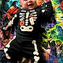 Sebastian joined the competition — help win amazing prizes! baby, infant, smiling, costume, skeleton_costume, halloween, black_clothing, orange, ghost, pumpkin, blanket, witch, colorful, lying_down, cute, happy, child, toddler, indoor, fun