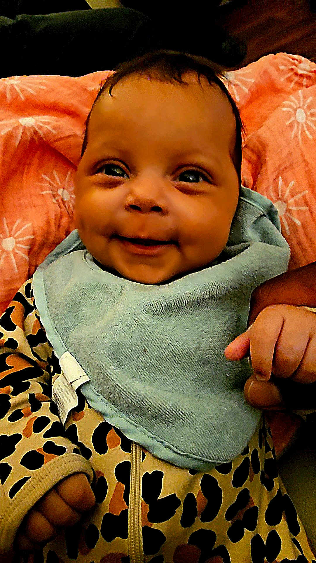 Myla joined the competition — help win amazing prizes! baby, smiling, infant, bib, leopard_print, clothing, blanket, hand, face, person, cute, happy, portrait, indoor, child, toddler, fabric, skin, head, eyes