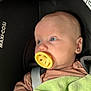 baby, pacifier, car_seat, maxi_cosi, blanket, blue_eyes, infant, child, seatbelt, clothing, portrait, face, head, closeup, indoors, soft_light, newborn, baby_girl_or_boy, baby_accessory, resting