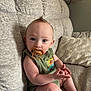 Jude is registered to the contest to win money with this photo: baby, pacifier, green_clothing, couch, gray_couch, indoor, child, infant, blue_eyes, sitting, plush_pillow, lamp, mohawk_hairstyle, cute, toddler, portrait, furniture, home_interior, person, relaxed