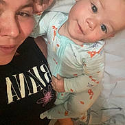 Arthur is registered to the contest to win money with this photo: baby, adult, bed, blanket, clothing, cute, face, family, female, home, infant, laying, love, person, pajamas, portrait, smile, together, young_child, happy