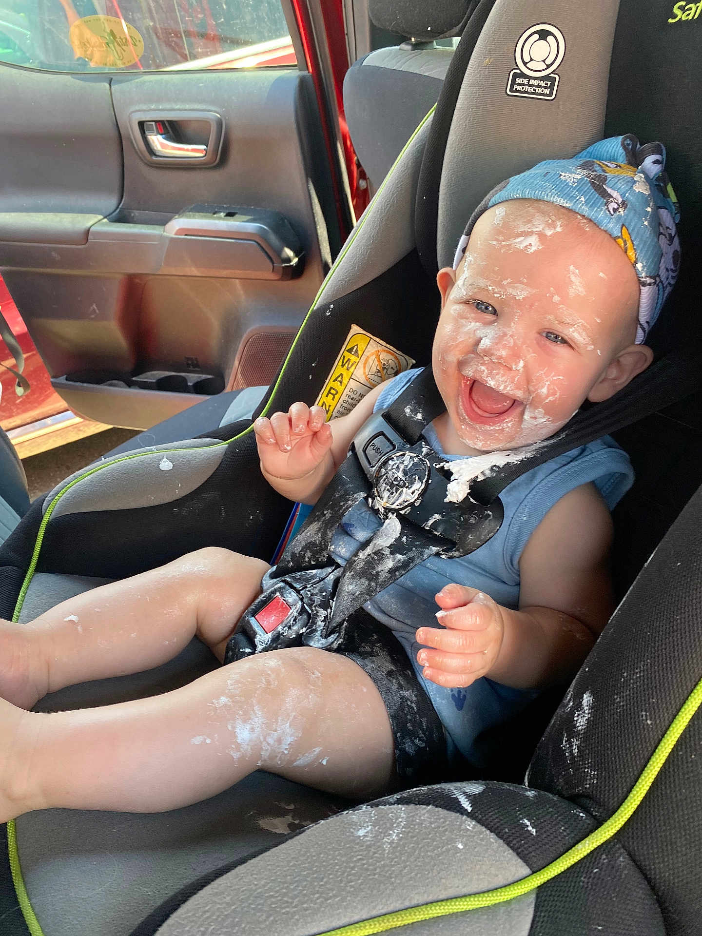 Arthur joined the competition — help win amazing prizes! baby, car_seat, car_interior, child, cream, messy, smiling, headband, seatbelt, happy, infant, clothing, sitting, vehicle, door, window, sunlight, cute, fun, playful