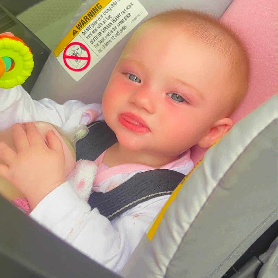 Rosina joined the competition — help win amazing prizes! baby, blue_eyes, bottle, car_interior, car_seat, child, child_safety, closeup, cute, face, happy, infant, inside_car, pink_clothing, portrait, rosy_cheeks, safety_harness, seatbelt, small_hand, toy
