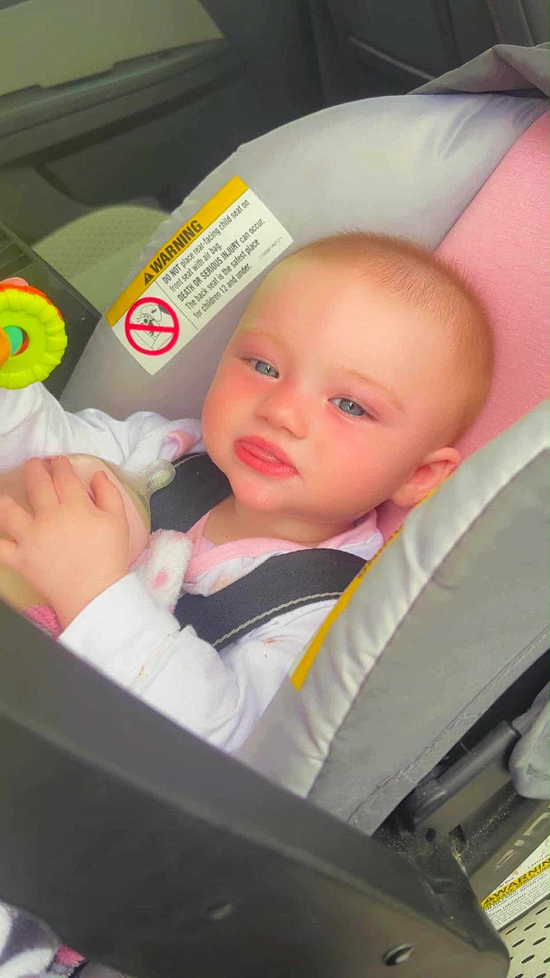 Rosina joined the competition — help win amazing prizes! baby, car_seat, child, bottle, toy, blue_eyes, pink_clothing, safety_harness, infant, inside_car, seatbelt, cute, rosy_cheeks, closeup, portrait, child_safety, car_interior, happy, small_hand, face