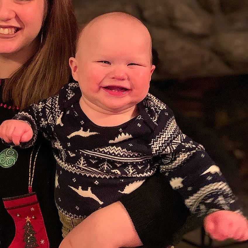 Finnegan is registered to the contest to win money with this photo: arm, cheek, child, facial_expression, finger, fun, joy, laugh, person, sitting, smile, toddler