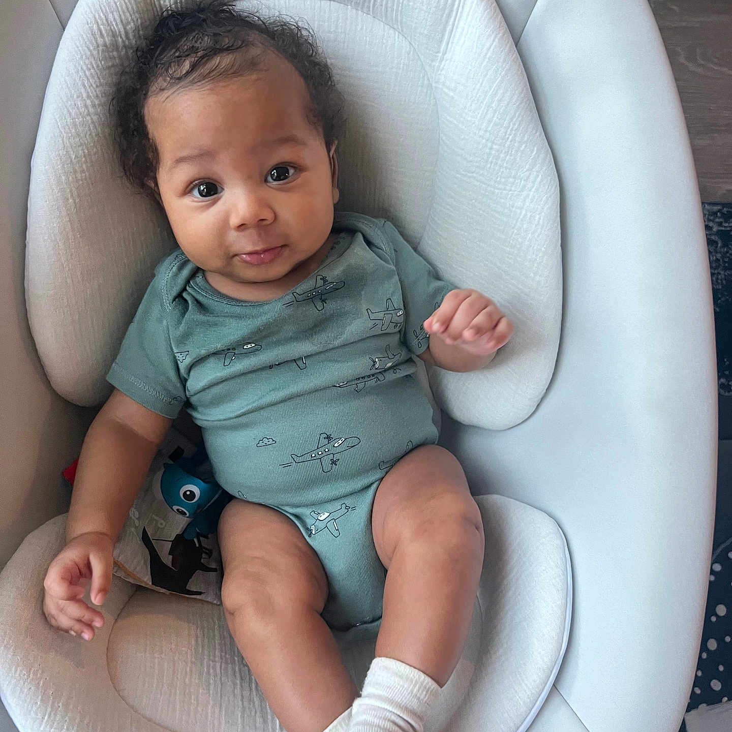 Ad joined the competition — help win amazing prizes! attention, baby, baby_seat, big_eyes, child, cozy, curly_hair, cushion, cute, hand, infant, legs, newborn, onesie, portrait, skin_tone, smile, sock, toy, wood_floor