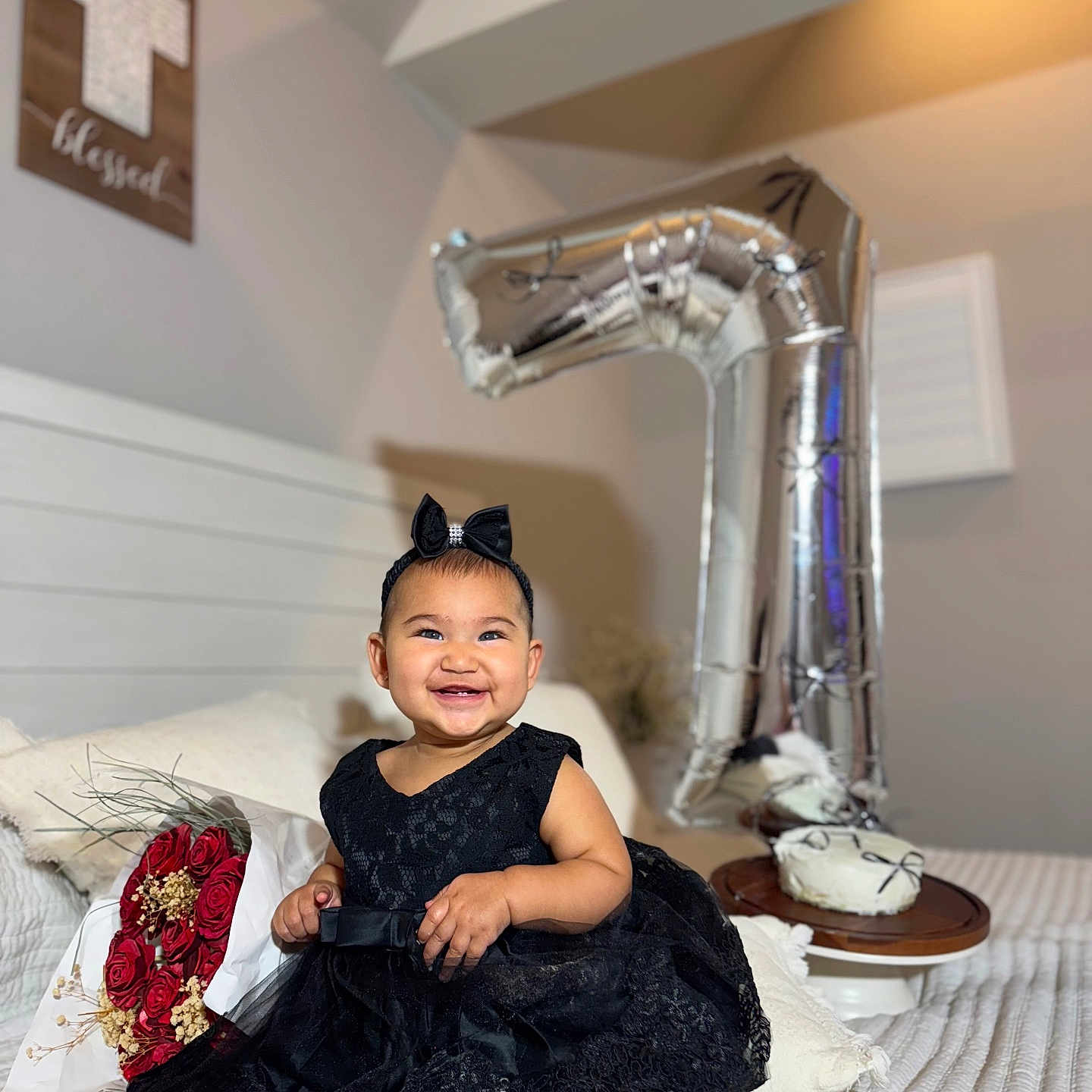 Georgina joined the competition — help win amazing prizes! baby, balloon, bed, black_dress, bouquet, bow_headband, cake, celebration, child, cute, flower, footwear, happy, headband, indoors, number_one, pillow, portrait, red_roses, smiling