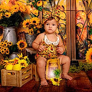 Celine Mendez is registered to the contest to win money with this photo: baby, daisy, face, flower, flowerarrangement, flowerbouquet, hardwood, head, jar, leaf, person, petal, photography, plant, portrait, pottedplant, pottery, sunflower, vase, wood
