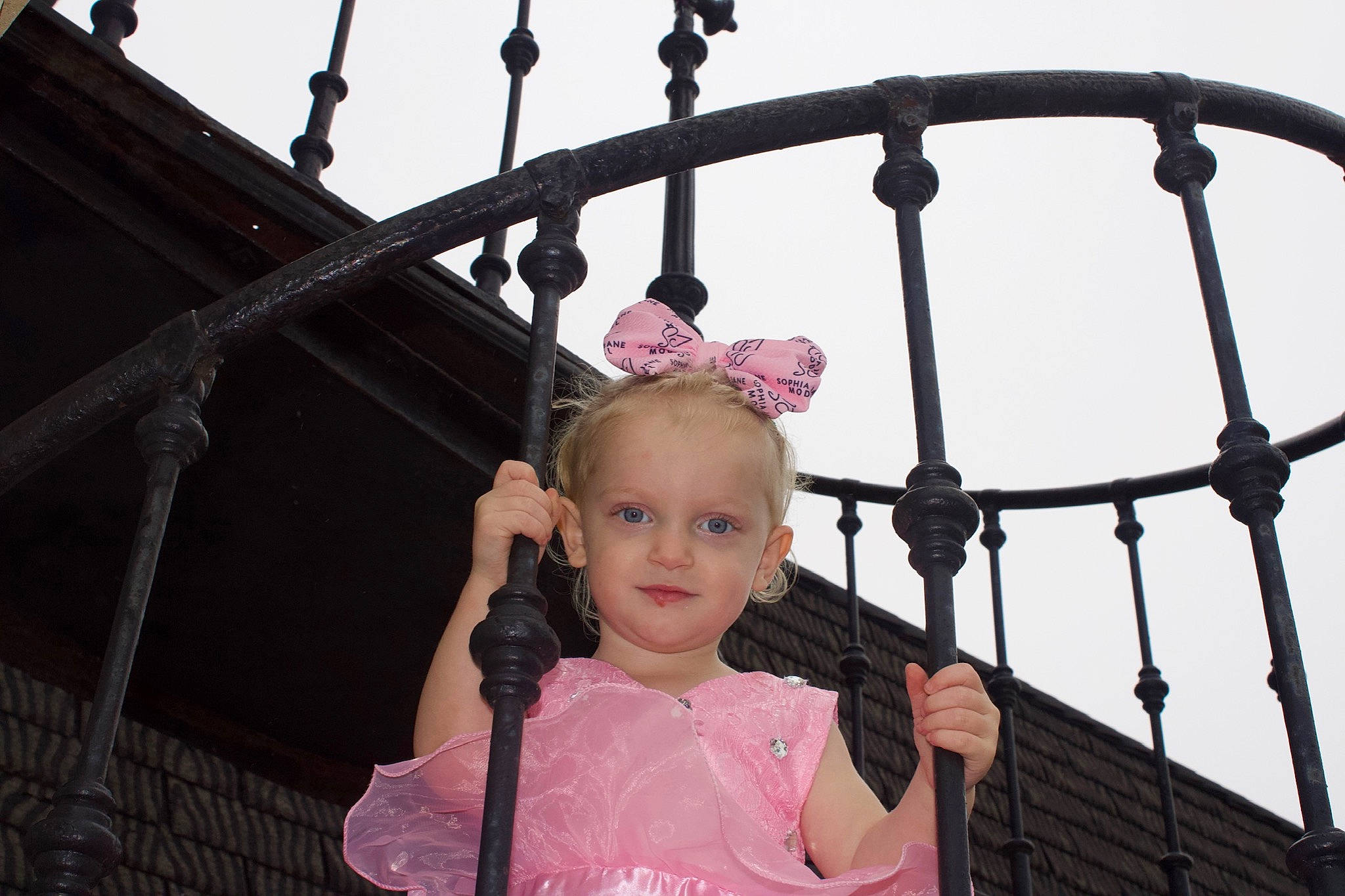 Hailie is registered to the contest to win money with this photo: baby, baby_toddler_clothing, baluster, beauty, building_material, cheek, child, child_model, embellishment, eyelash, hair_accessory, handrail, iron, joy, metal, mouth, person, pink, toddler