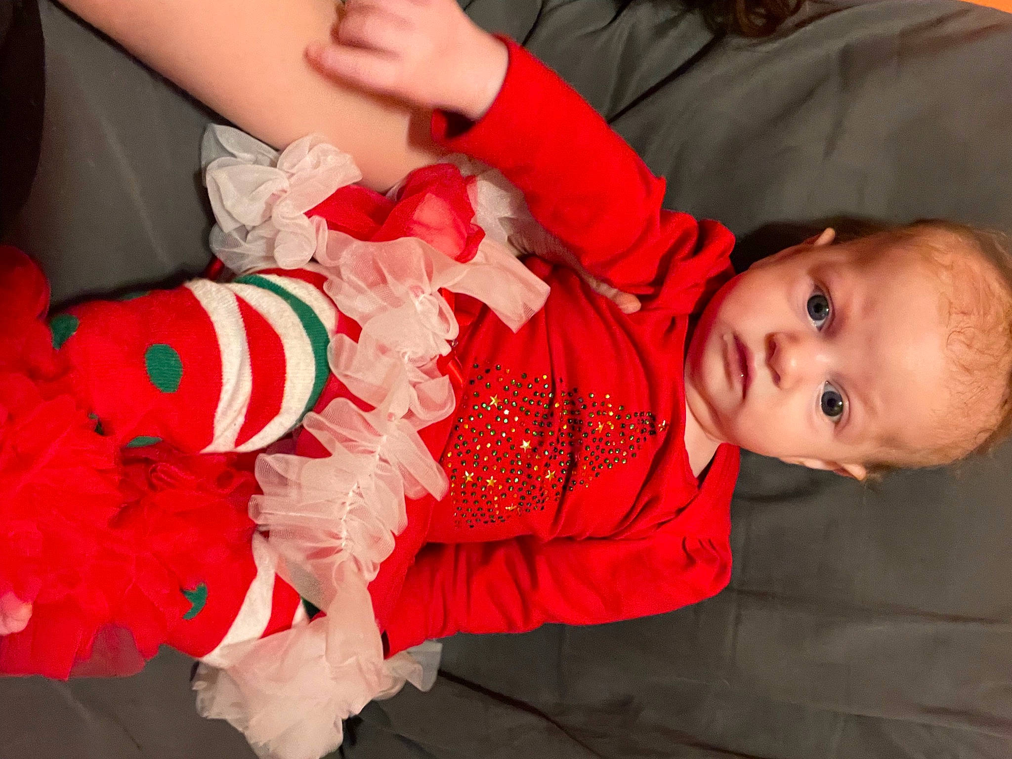 Sophia is registered to the contest to win money with this photo: arm, baby, baby_toddler_clothing, child, design, event, facial_expression, finger, fun, gesture, hand, happy, human_body, mammal, orange, person, skin, sleeve, toddler, tradition