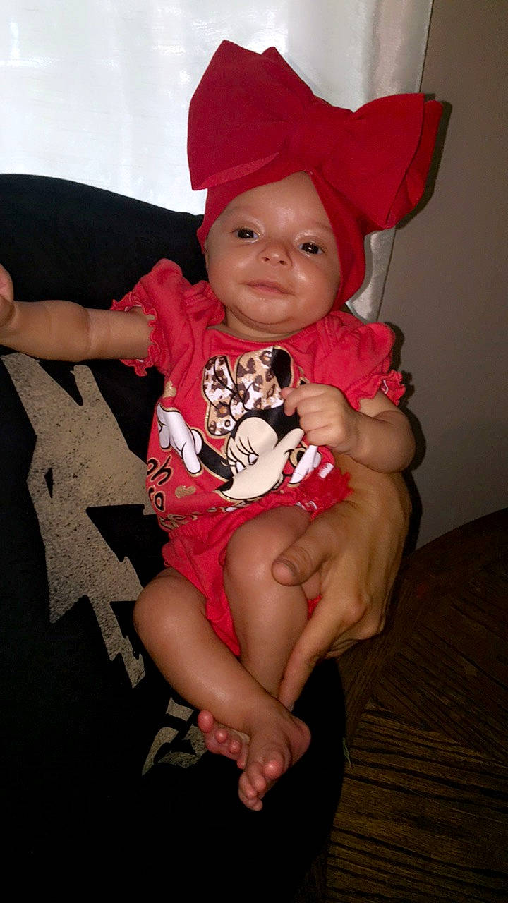 Brooklynn is registered to the contest to win money with this photo: arm, baby, baby_toddler_clothing, cap, comfort, costume_hat, eye, fun, headgear, headwear, knee, lap, mouth, neck, person, pink, skin, sleeve, smile, t_shirt