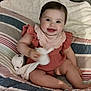 Aloïs participe au concours pour gagner de l'argent avec cette photo : baby, child, smiling, sitting, plush_toy, bed, blanket, quilt, clothing, person, cute, happy, indoor, infant, toy, comfort, young_child, face, portrait, ruffled_dress