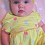 baby, infant, yellow_dress, headband, flower, pink_blanket, hearts, cute, child, portrait, smiling, soft_texture, indoor, closeup, skin, person, happy, toddler, lying_down, apparel