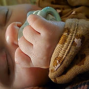 Ella is registered to the contest to win money with this photo: baby, sleeping, pacifier, hand, face, skin, clothing, brown, pattern, closeup, infant, peaceful, cute, soft, cozy, child, newborn, portrait, resting, fingers