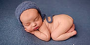 Arthur participe au concours pour gagner de l'argent avec cette photo : newborn, baby, sleeping, blue_bonnet, blue_blanket, curled_up, infant, soft_skin, peaceful, portrait, close_up, cute, tiny_fingers, tiny_toes, resting, cozy, studio_photo, headwear, child, serene