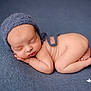 newborn, baby, sleeping, blue_bonnet, blue_blanket, curled_up, infant, soft_skin, peaceful, portrait, close_up, cute, tiny_fingers, tiny_toes, resting, cozy, studio_photo, headwear, child, serene