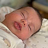 Jaxson is registered to the contest to win money with this photo: baby, sleeping, infant, closeup, face, rosy_cheeks, blanket, stars_pattern, soft_lighting, newborn, peaceful, resting, skin, eyelashes, mouth, nose, head, clothing, indoors, portrait
