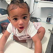 Hylence is registered to the contest to win money with this photo: baby, bathroom, candle, child, closeup, counter, curious, cute, exploring, face, hair_bow, hair_straightener, indoor, jar, jumbo_olives, person, socks, striped_overall, toddler, white_shirt