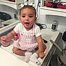 Hylence joined the competition — help win amazing prizes! chair, child, countertop, cup, cute, expression, face, household_items, indoor, kitchen, mirror, person, pink_striped_dress, pot, reflection, sitting, socks, toddler, toothbrush, white_bows