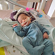 Journe'E joined the competition — help win amazing prizes! baby, infant, sleeping, hospital, crib, medical_tubes, blanket, blue_onesie, headband, bow, monitor, healthcare, child, pediatric, cute, cozy, bed, soft_toys, nursery, resting