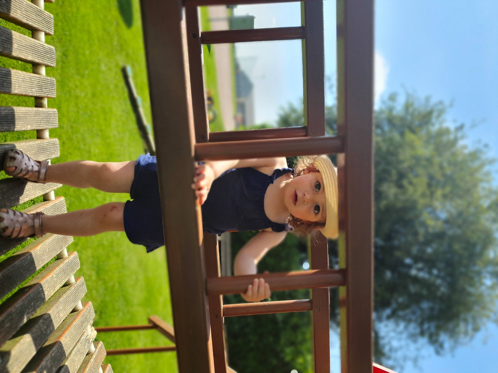 Romy participe au concours pour gagner de l'argent avec cette photo : door, fun, grass, handrail, hat, headwear, house, leisure, metal, person, plant, property, recreation, room, shorts, sitting, sky, smile, stairs, tree
