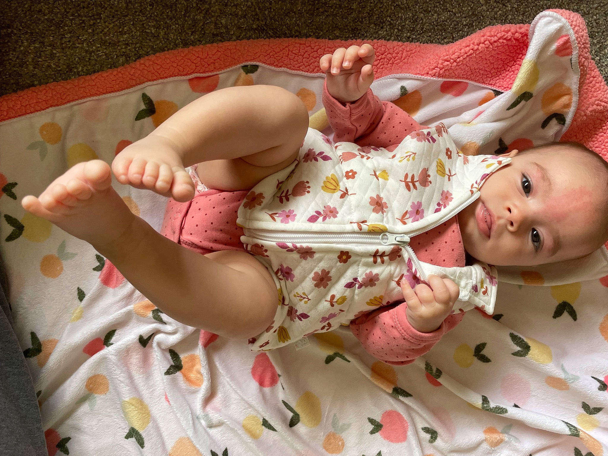 Ezmae is registered to the contest to win money with this photo: baby, baby_products, baby_toddler_clothing, cheek, child, comfort, finger, hand, head, human_body, human_leg, linens, pattern, person, pink, product, skin, sleeve, textile, thigh