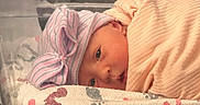 Presley is registered to the contest to win money with this photo: newborn, baby, infant, hospital, bassinet, blanket, hat, bow, sleeping, face, cute, wrapped, child, bed, resting, footprints, pattern, pink, soft, peaceful