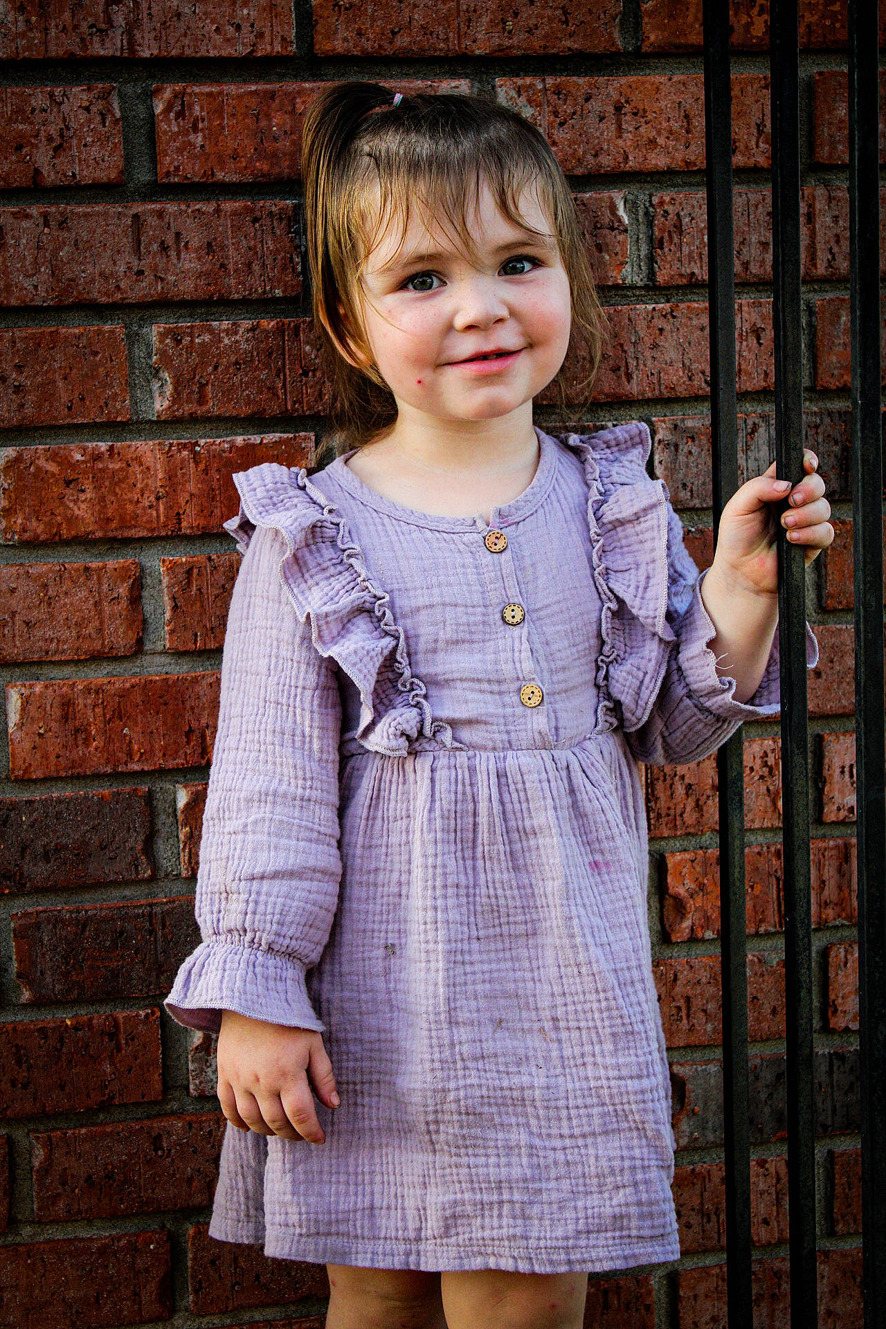 Annaliese joined the competition — help win amazing prizes! baby_toddler_clothing, bangs, brick, brickwork, button, child, child_model, clothing, day_dress, dress, embellishment, iris, joy, one_piece_garment, pattern, person, portrait_photography, sleeve, toddler
