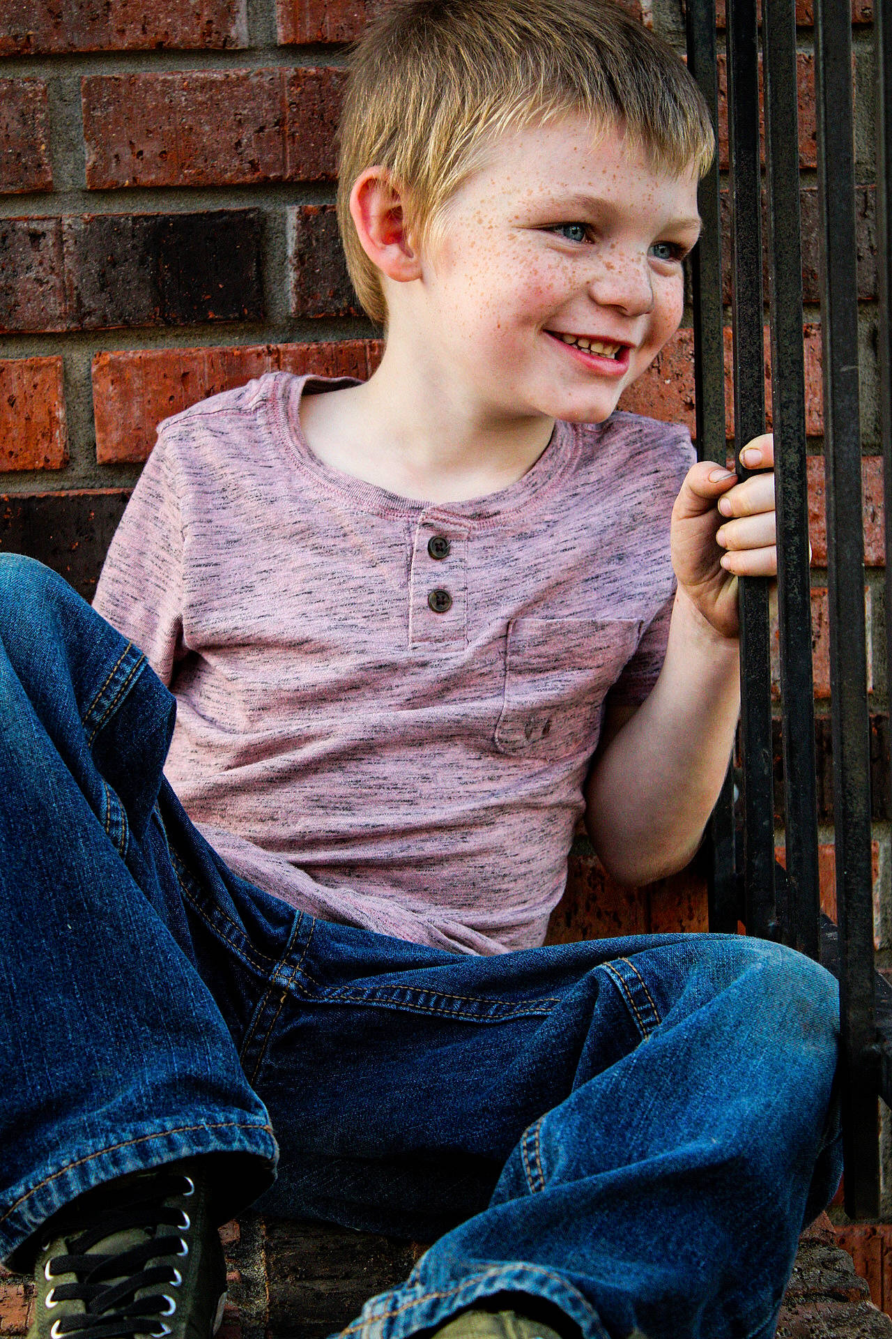 Michael joined the competition — help win amazing prizes! blond, brick, brickwork, caesar_cut, child_model, denim, ear, fence, home_fencing, jeans, joy, lap, laugh, outdoor_shoe, person, sitting, sock, thumb, tooth, walking_shoe