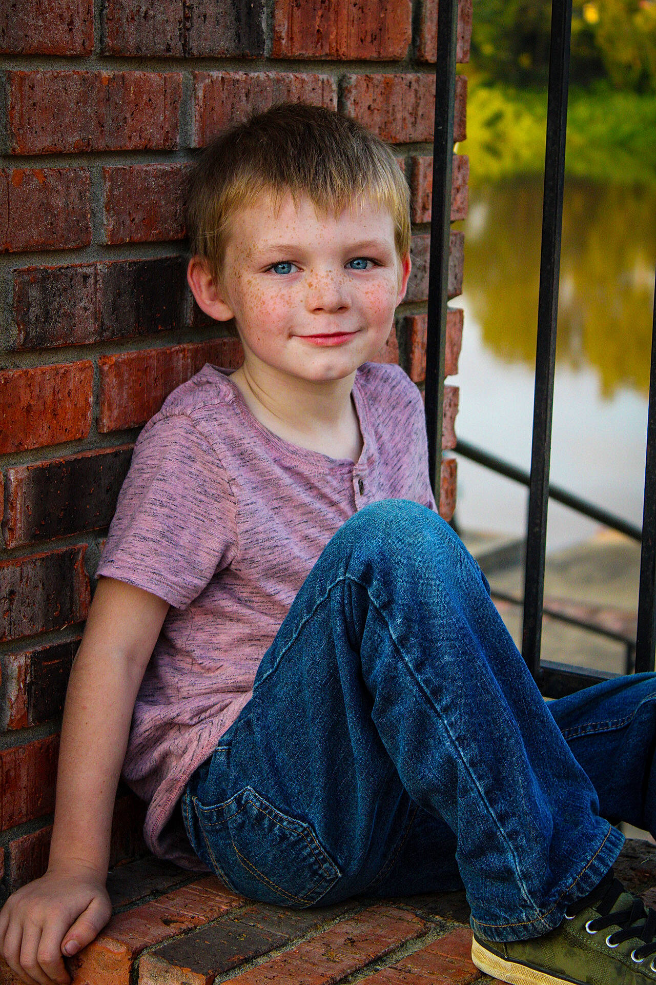 Michael is registered to the contest to win money with this photo: ankle, brick, brickwork, child_model, denim, foot, jeans, joy, mortar, mouth, outdoor_shoe, person, portrait_photography, sitting, slipper